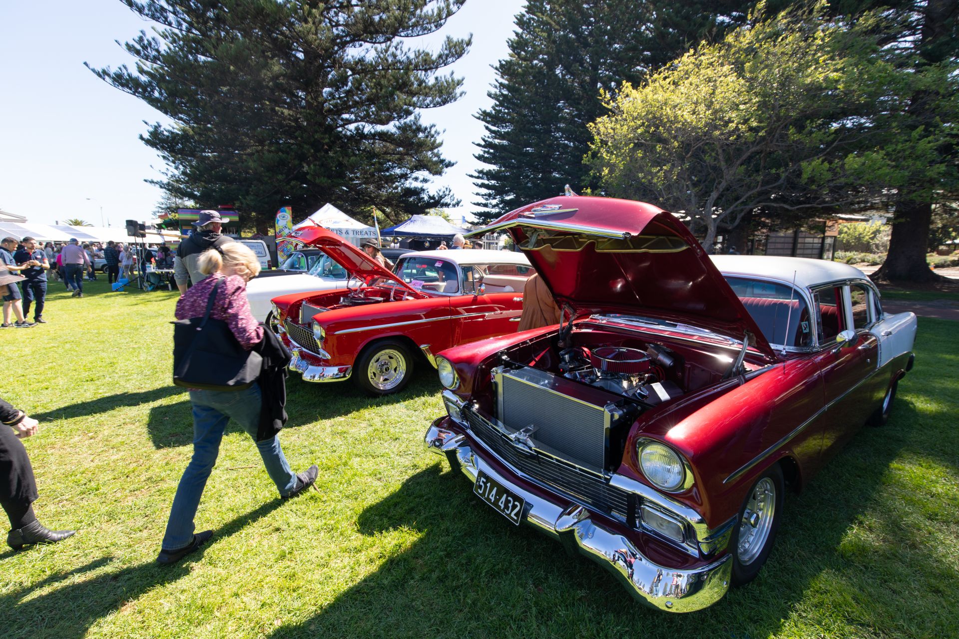 Red classic cars with bonnet up at 2023 Rock 'N' Roll Festival