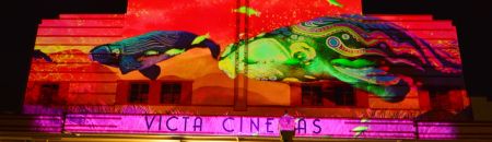 Whale art projection onto Victa Cinema building facade