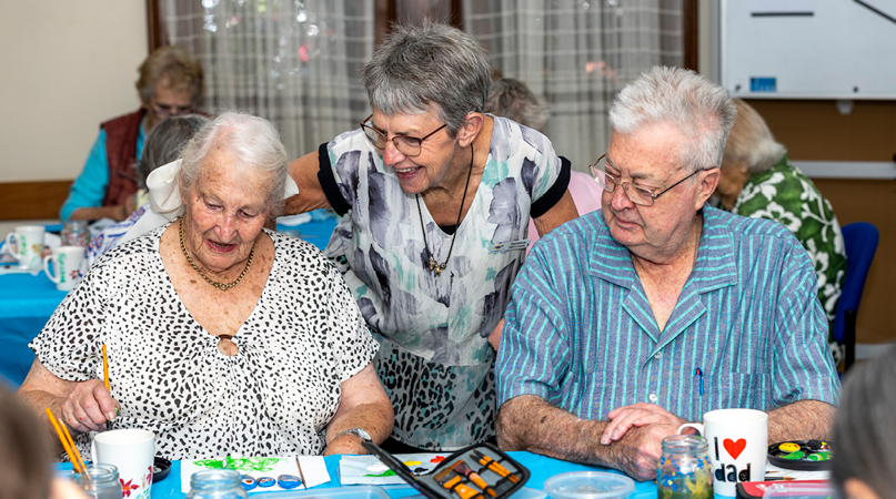 Volunteer helping people to create art