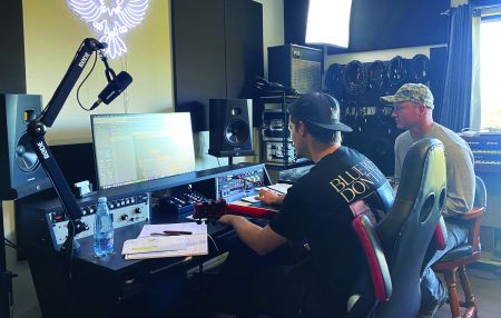 Two young men sitting at a mixing desk